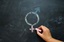 Gender sign being drawn onto a chalk board