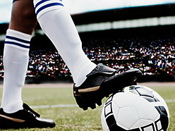 a person kicking a football ball