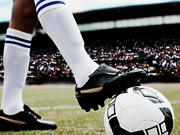 a person kicking a football ball
