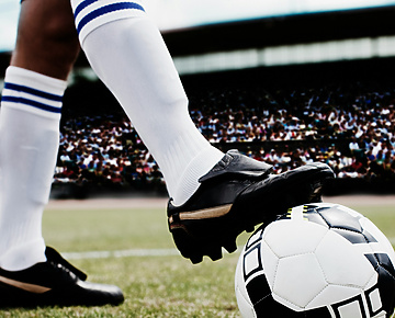 a person kicking a football ball