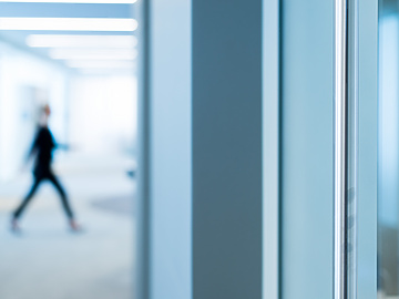 Blurred figure walking in Mishcon de Reya offices