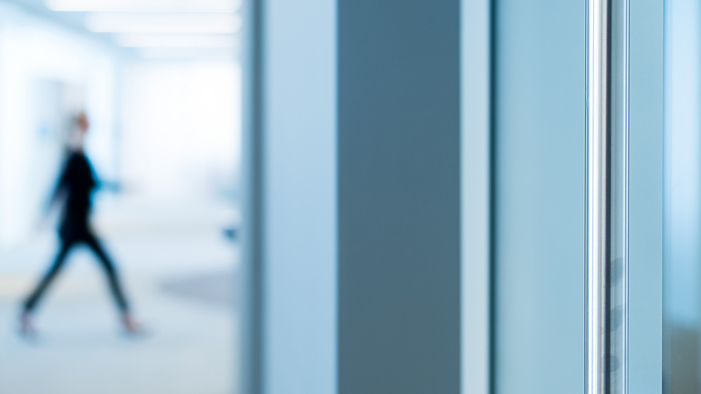 person walking through work building