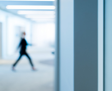 person walking through work building