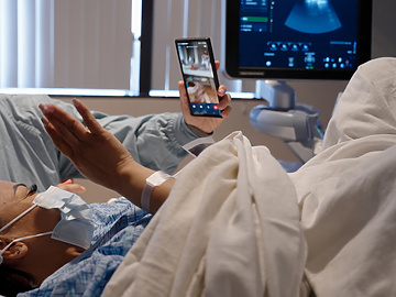 Surrogate in hospital bed on facetime