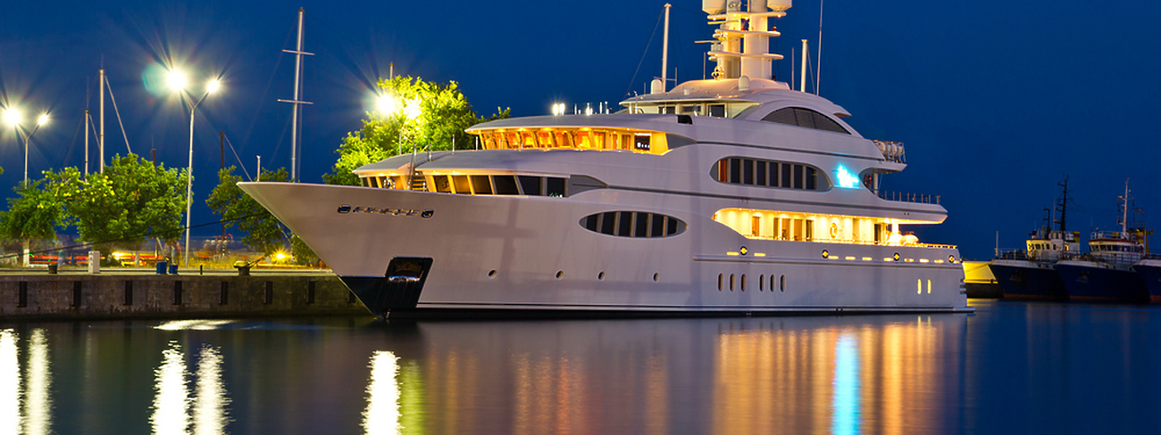 a large white boat in water at night