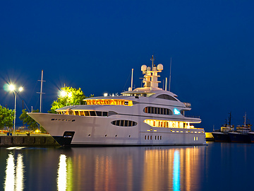 a large white boat in water at night