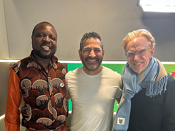 a group of men standing together smiling