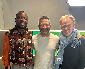 a group of men standing together smiling