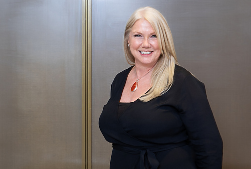 a person in black dress smiling