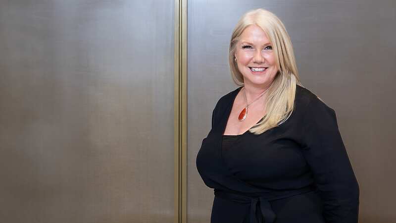 a person in black dress smiling