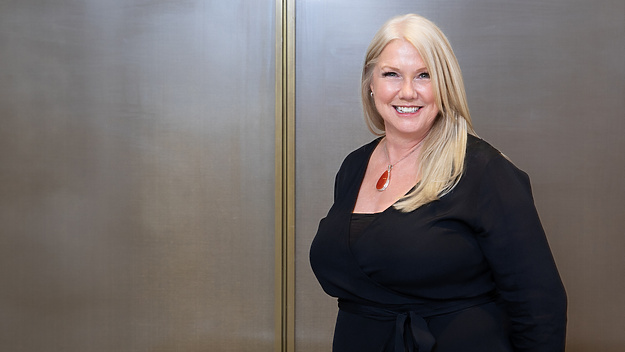 a person in black dress smiling