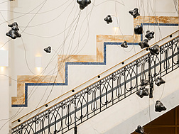 a staircase with black objects from it