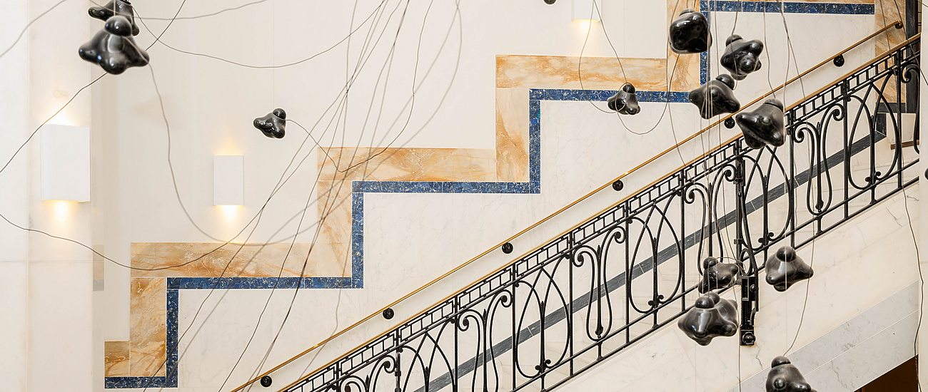 a staircase with black objects from it