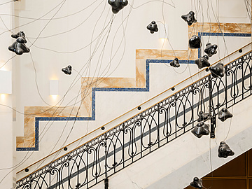a staircase with black objects from it