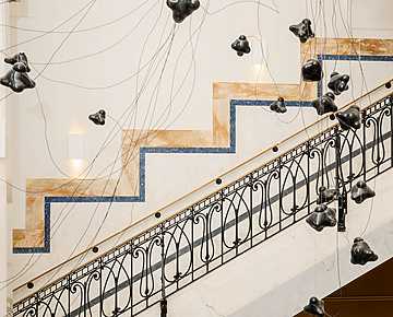 a staircase with black objects from it