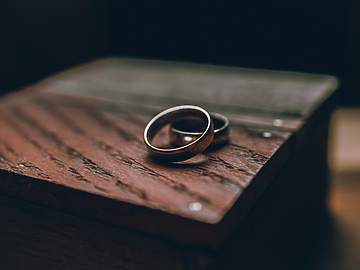 a pair of rings on a wood surface