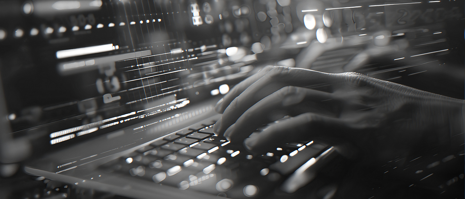 Person typing on a lit up laptop