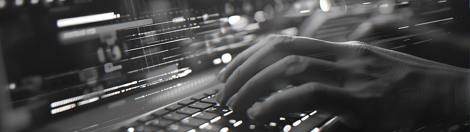 Person typing on a lit up laptop