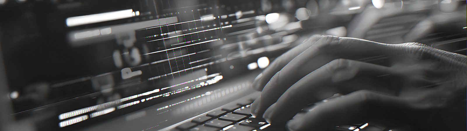 Person typing on a lit up laptop