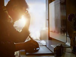 Shot of stressed man using digital graphic tablet while working at modern office