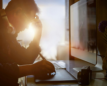 Shot of stressed man using digital graphic tablet while working at modern office