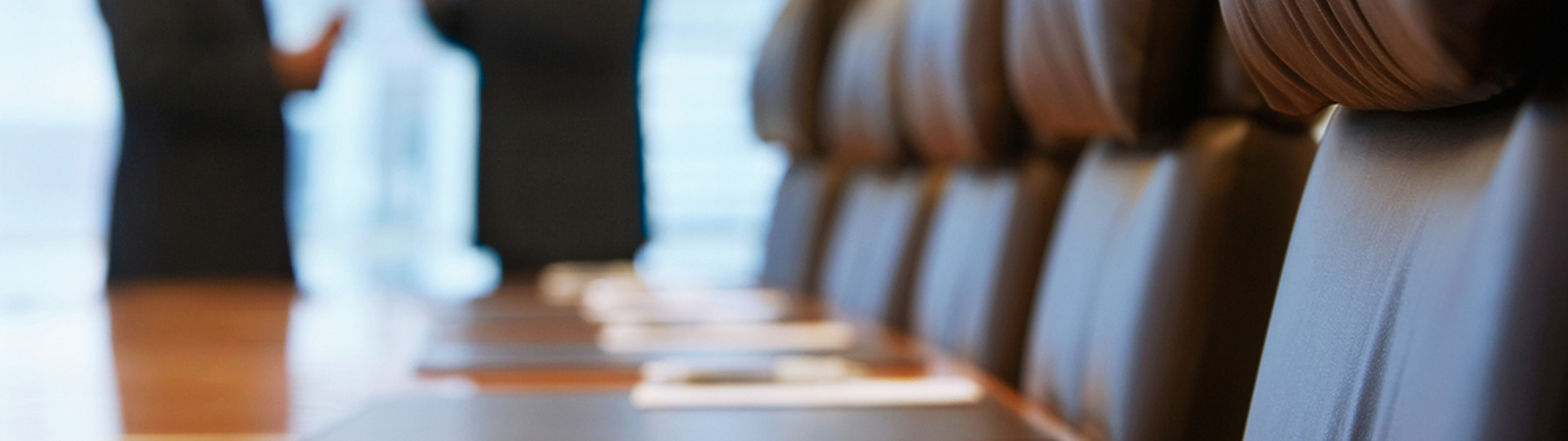 a pen on a table in a conference room with people talking in the background