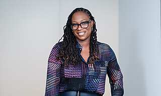 a person wearing glasses and a blue and purple shirt