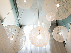 a group of white lights from the ceiling