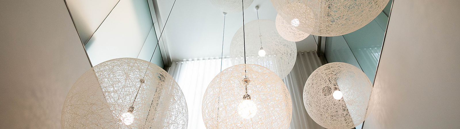 a group of white lights from the ceiling