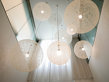 a group of white lights from the ceiling