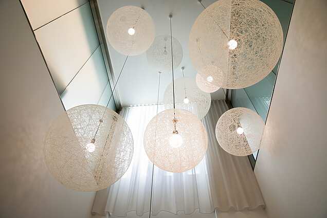 a group of white lights from the ceiling