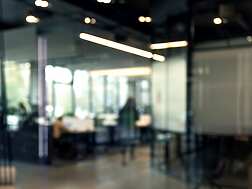 a blurry image of an office with a person in the background