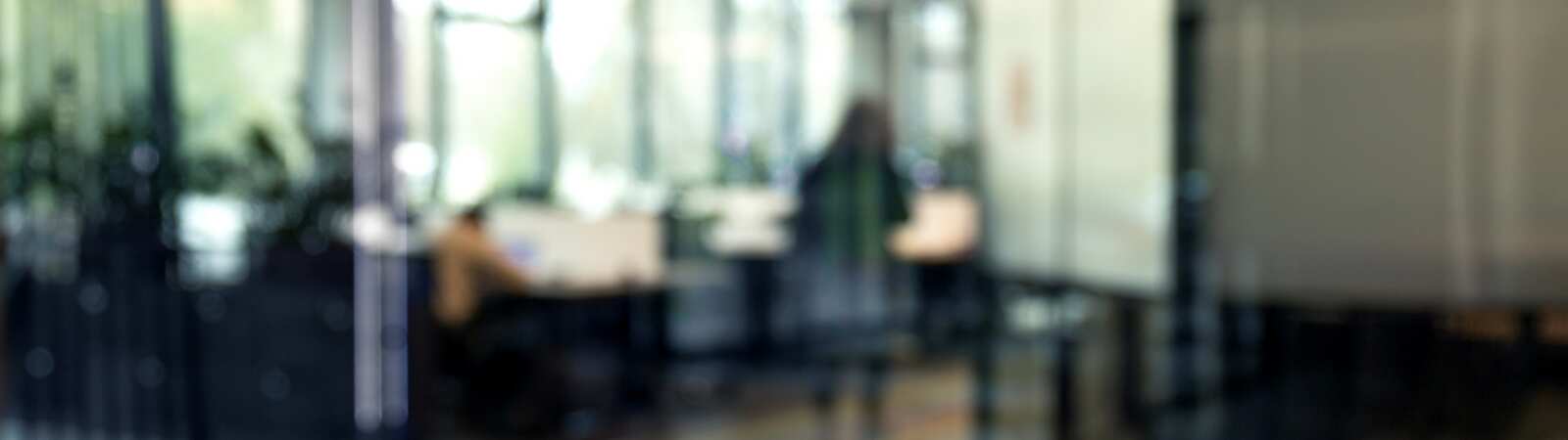 a blurry image of an office with a person in the background