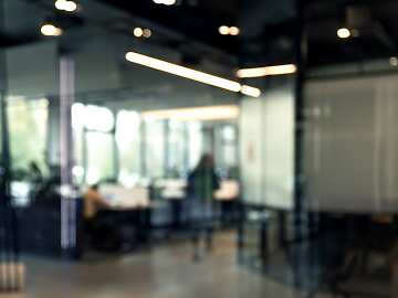 a blurry image of an office with a person in the background