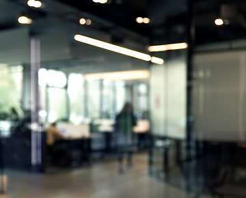 a blurry image of an office with a person in the background