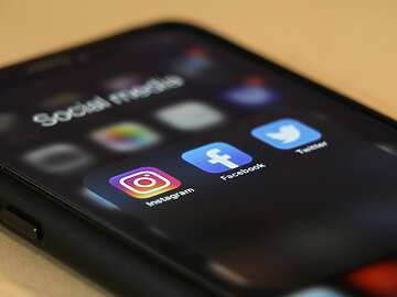 a close up of a phone with social media apps