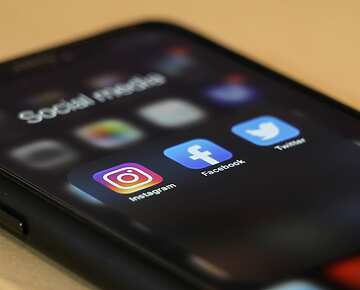 a close up of a phone with social media apps