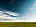 Wind turbines in field under blue sky