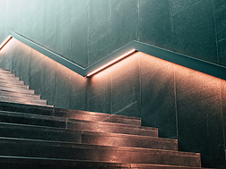 a staircase with lights on the wall