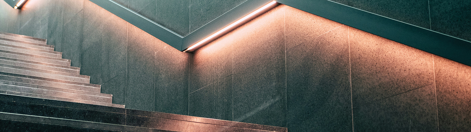 a staircase with lights on the wall