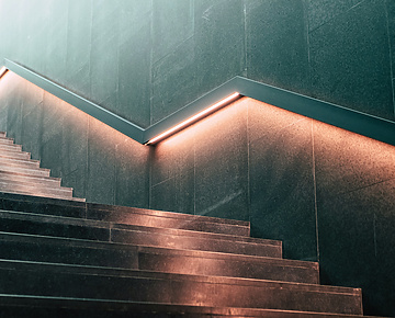 a staircase with lights on the wall