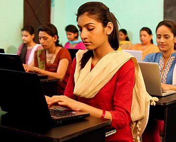 a person in a red dress using a laptop
