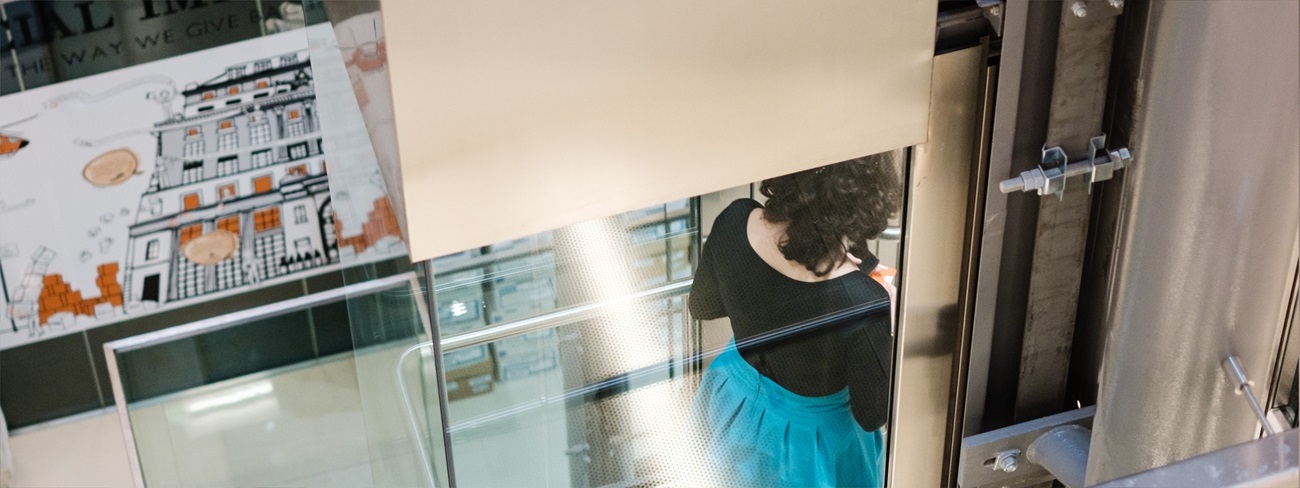 Mishcon employee standing in lift in Africa House