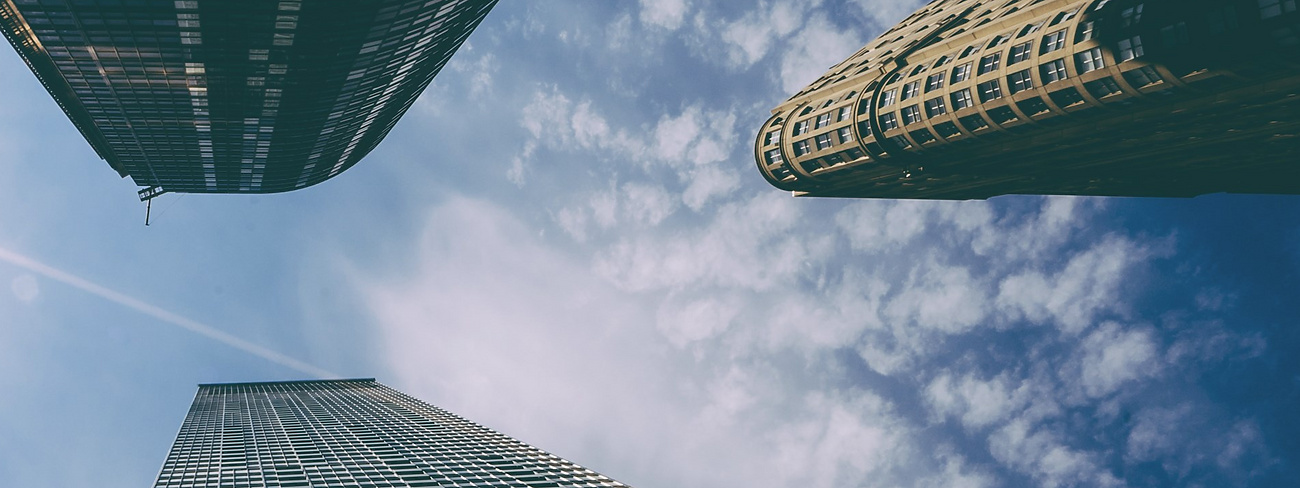 looking up view of tall buildings