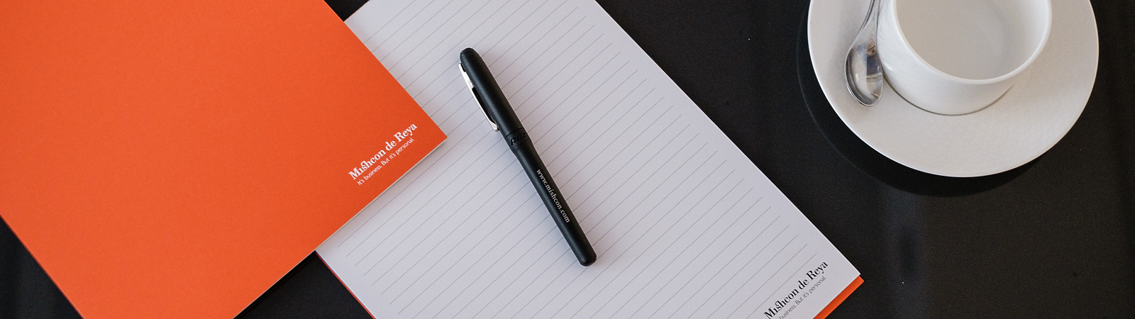 Mishcon pen and paper next to tea cup