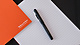 Mishcon pen and paper next to tea cup