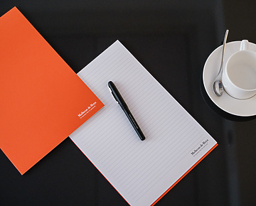 Mishcon pen and paper next to tea cup