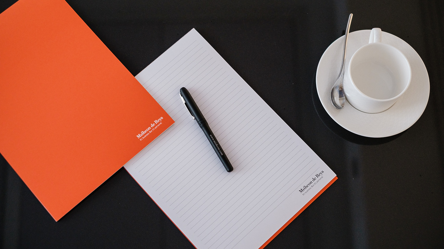 Mishcon pen and paper next to tea cup