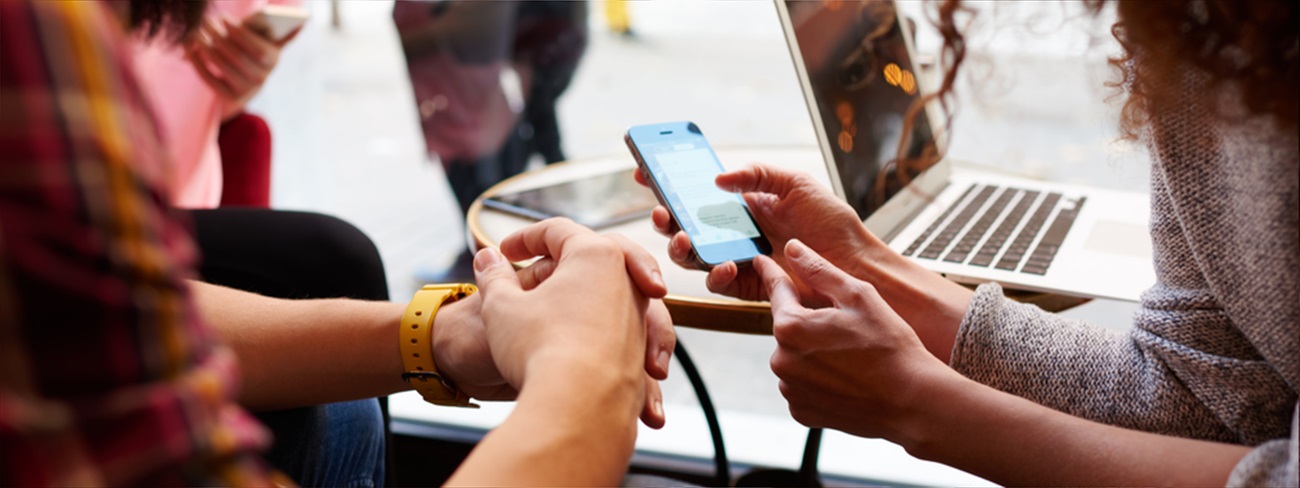 Two people viewing content on a mobile phone