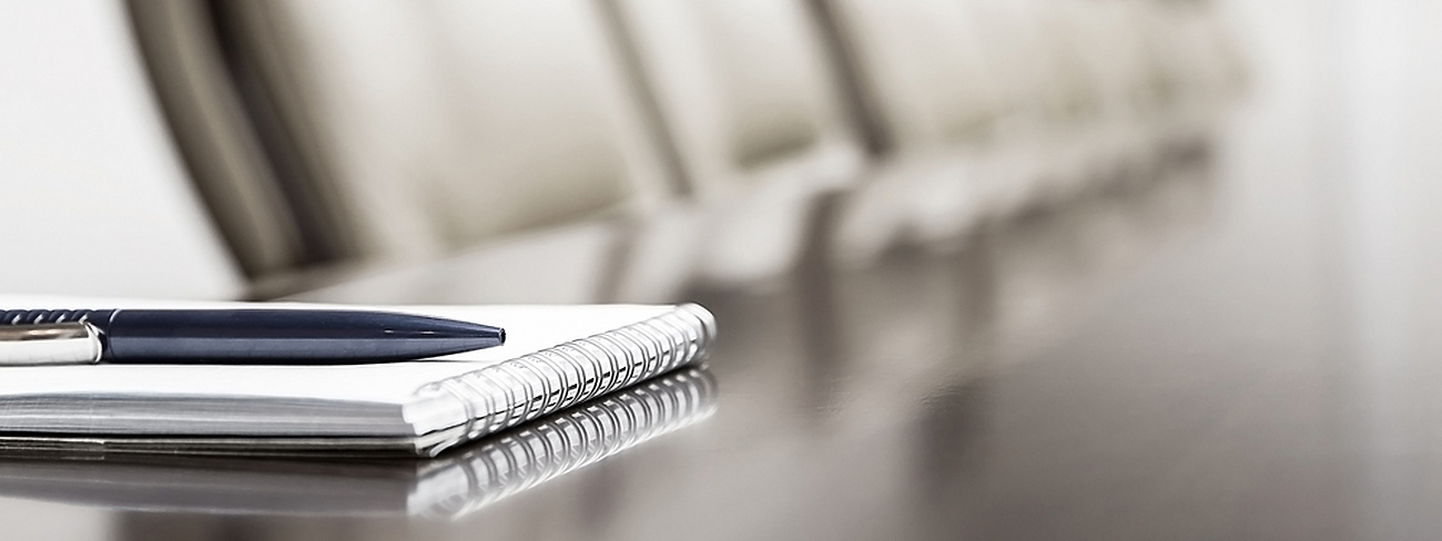 a pen on a spiral bound notebook
